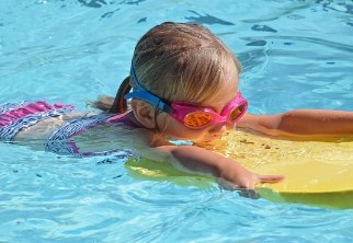 young girl learning to swim